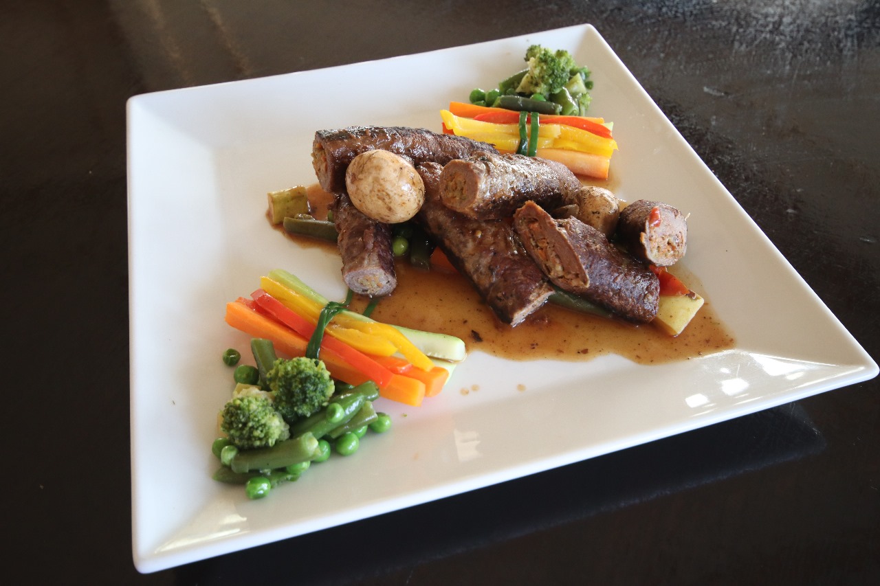 A chef carefully plating a dish in a luxury restaurant